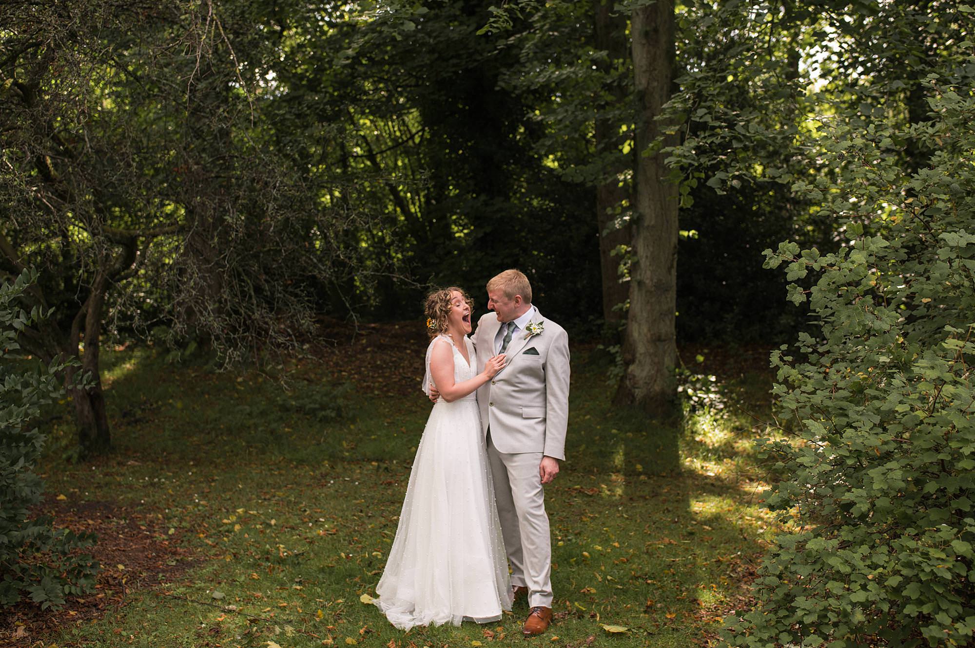 Bride & groom embrace in the botanic gardens in glasgow