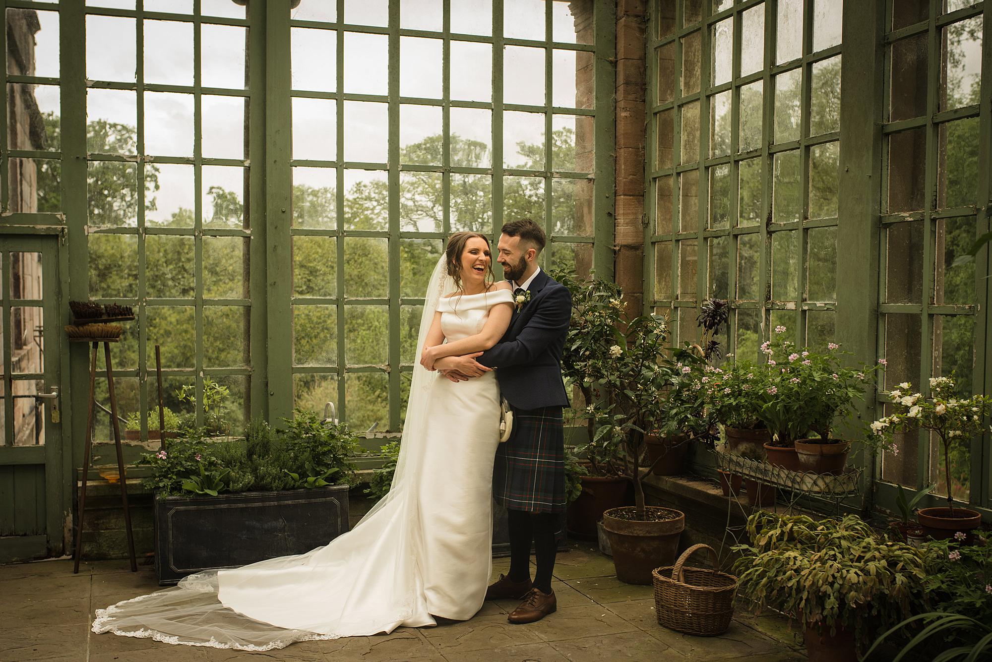 Couple embrace at Ardgowan House
